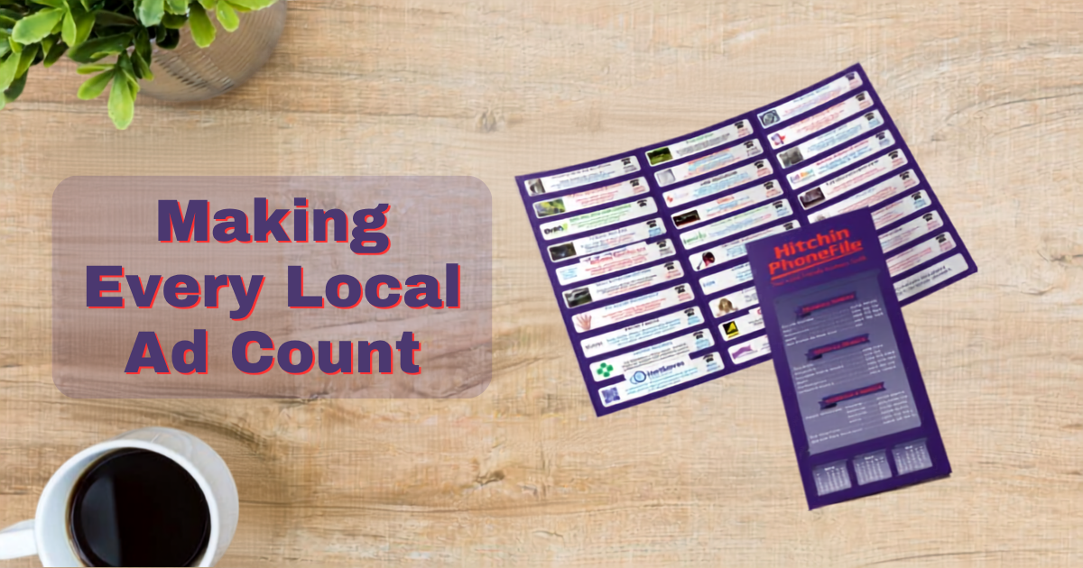 The PhoneFile business guide beside a coffee cup on a wooden table, with the text ‘Making Every Local Ad Count’