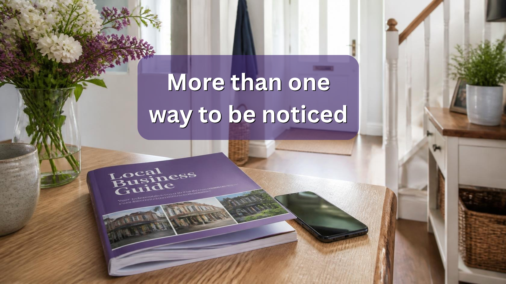 Local business guide and smartphone on a hallway table with the words “More than one way to be noticed”.